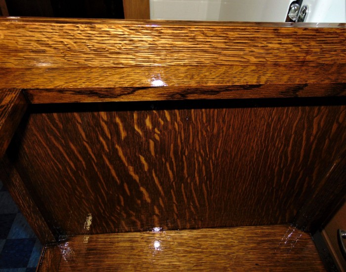 Inside of the cabinet with the original color on the wood strip