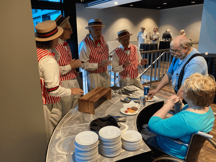 There was a social time after load in on Friday.  In addition to excellent bites and available beverages there was an outstanding barbershop quartet.  This photo was so touching because the sole focus of the singers was directed to the lady in the wheelchair.  Perfect!